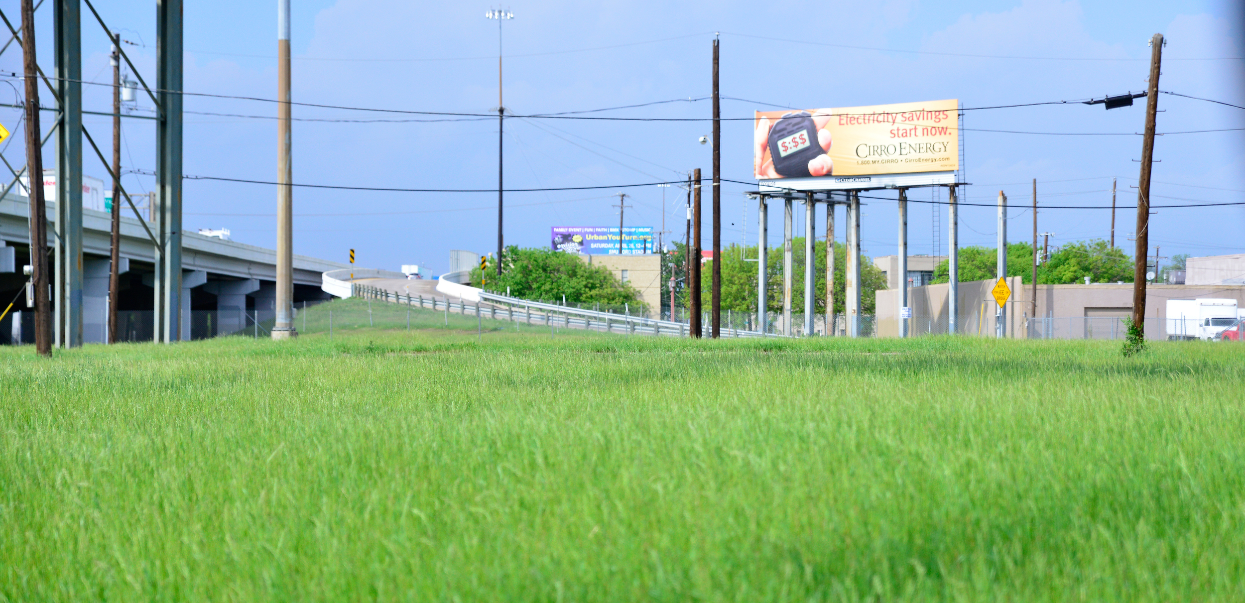 Looking across an urban meadow to the&nbsp;East bound entrance of I-30.