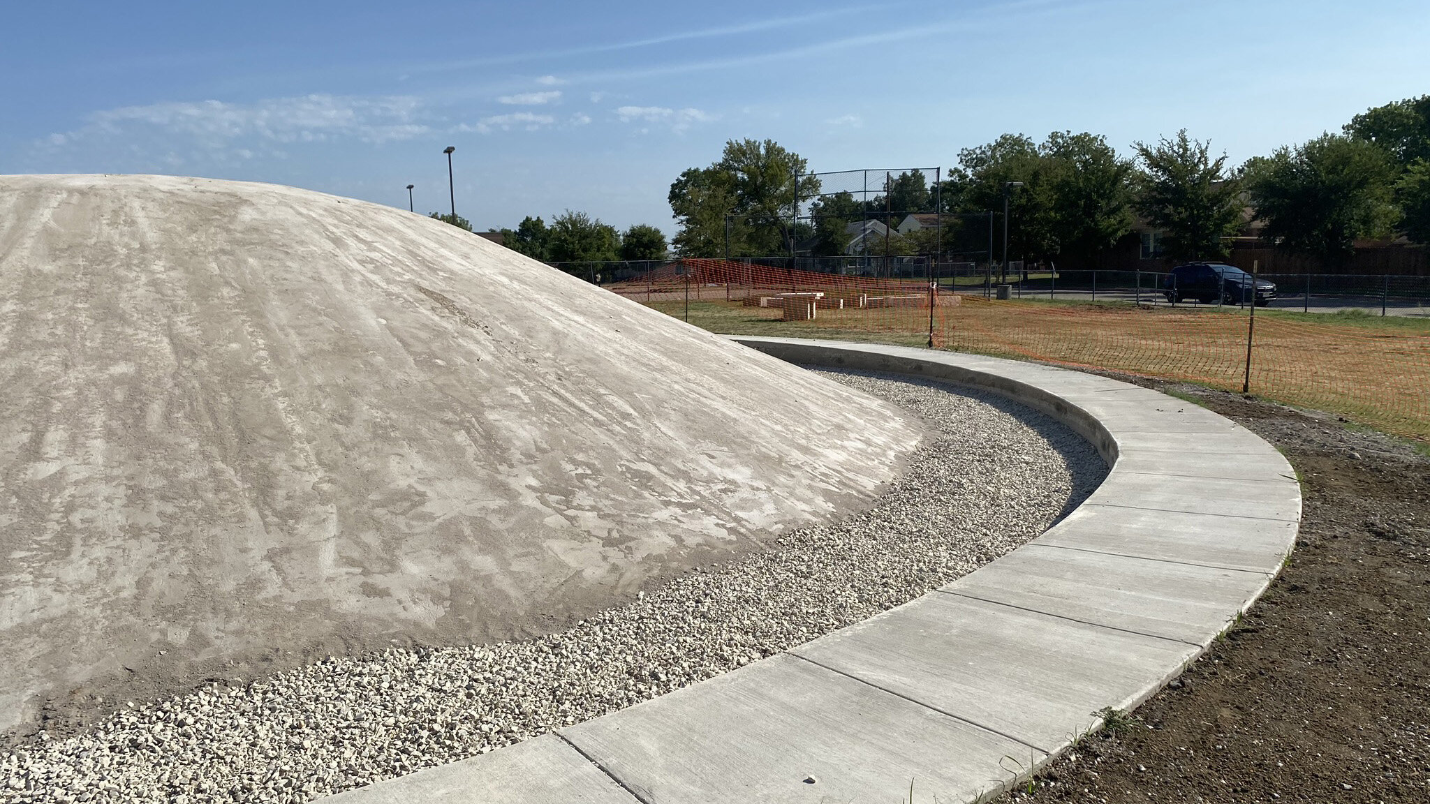  The playground at Arturo Salazar Elementary School also features a large turf mound, here it is under construction awaiting a layer of padding before the turf is installed. 
