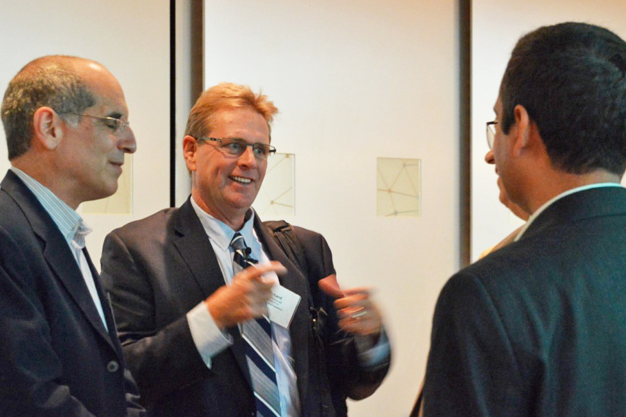 Rick Weiss & Richard Purcell speaking with attendees.