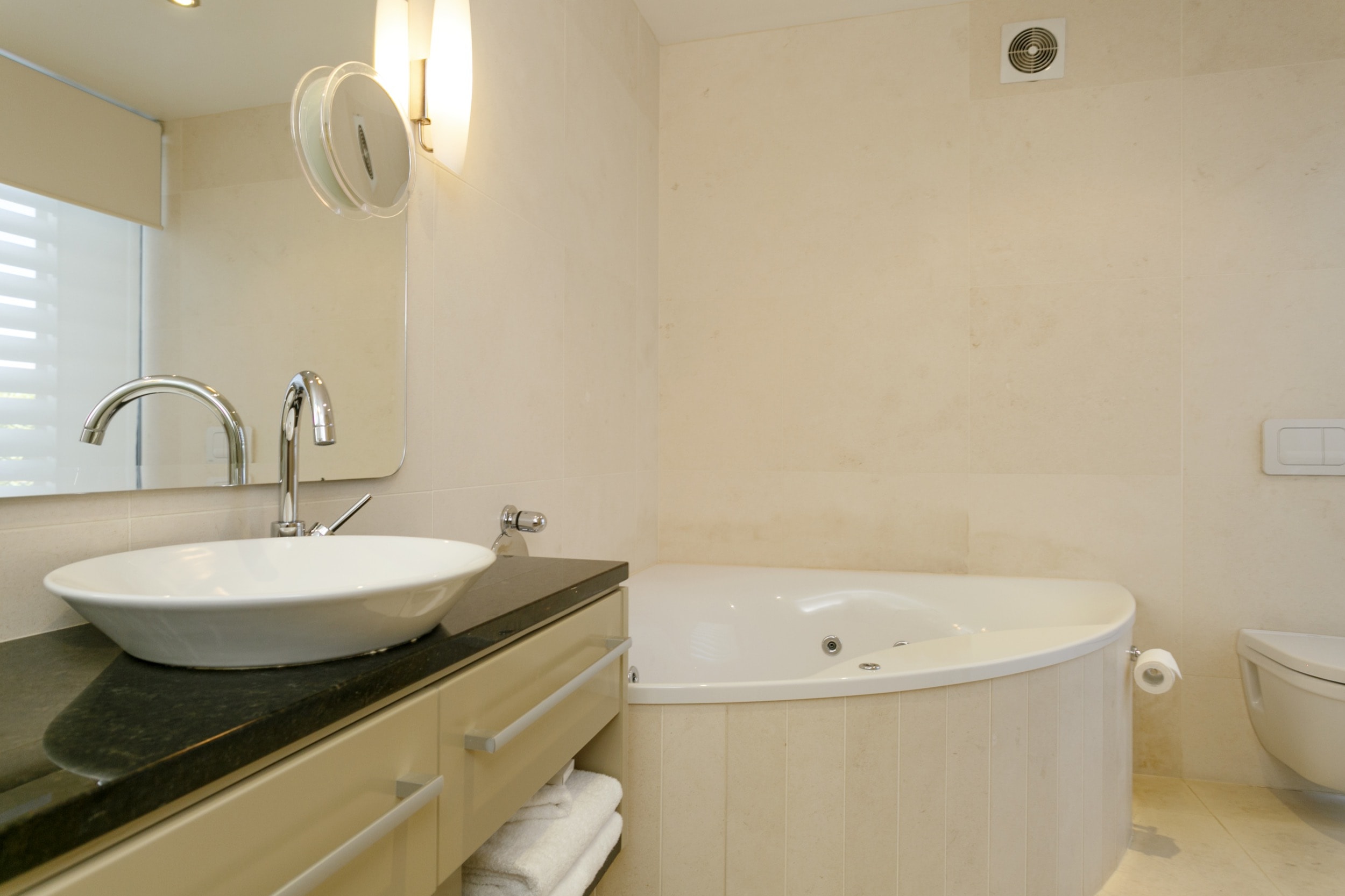 Ground floor two bedroom apartment master bedroom ensuite bathroom with spa bath 2.jpg