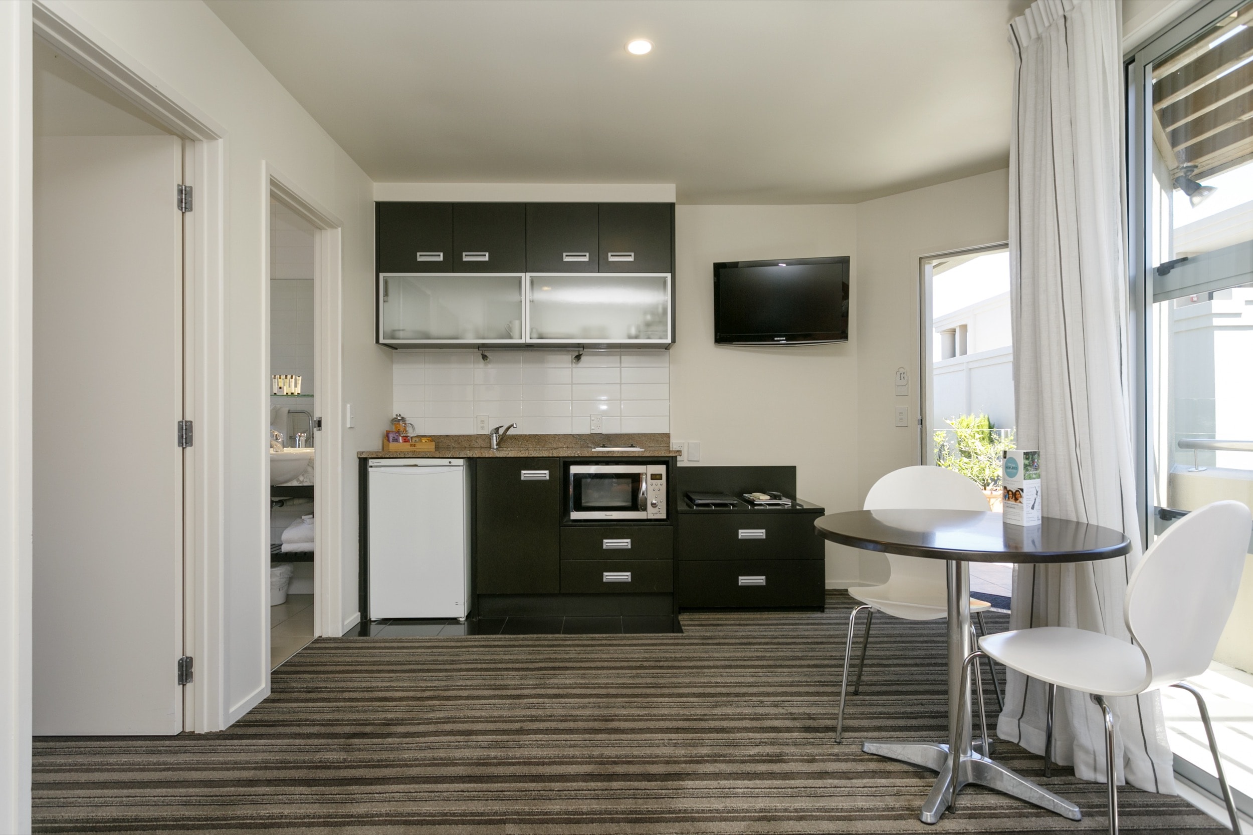 One Bedroom Gardev View living area lookig at kitchenette showing doors to bedroom and bathroom 2-min.jpg