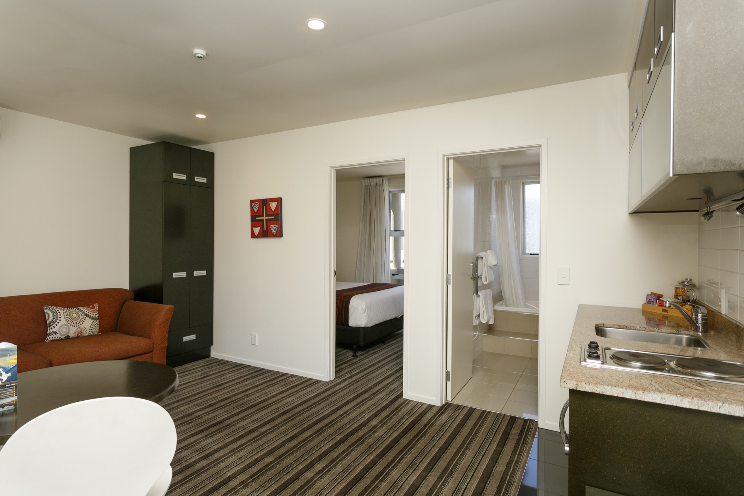 One Bedroom Gardev View living area looking at doors to bedroom and bathroom-min.jpg