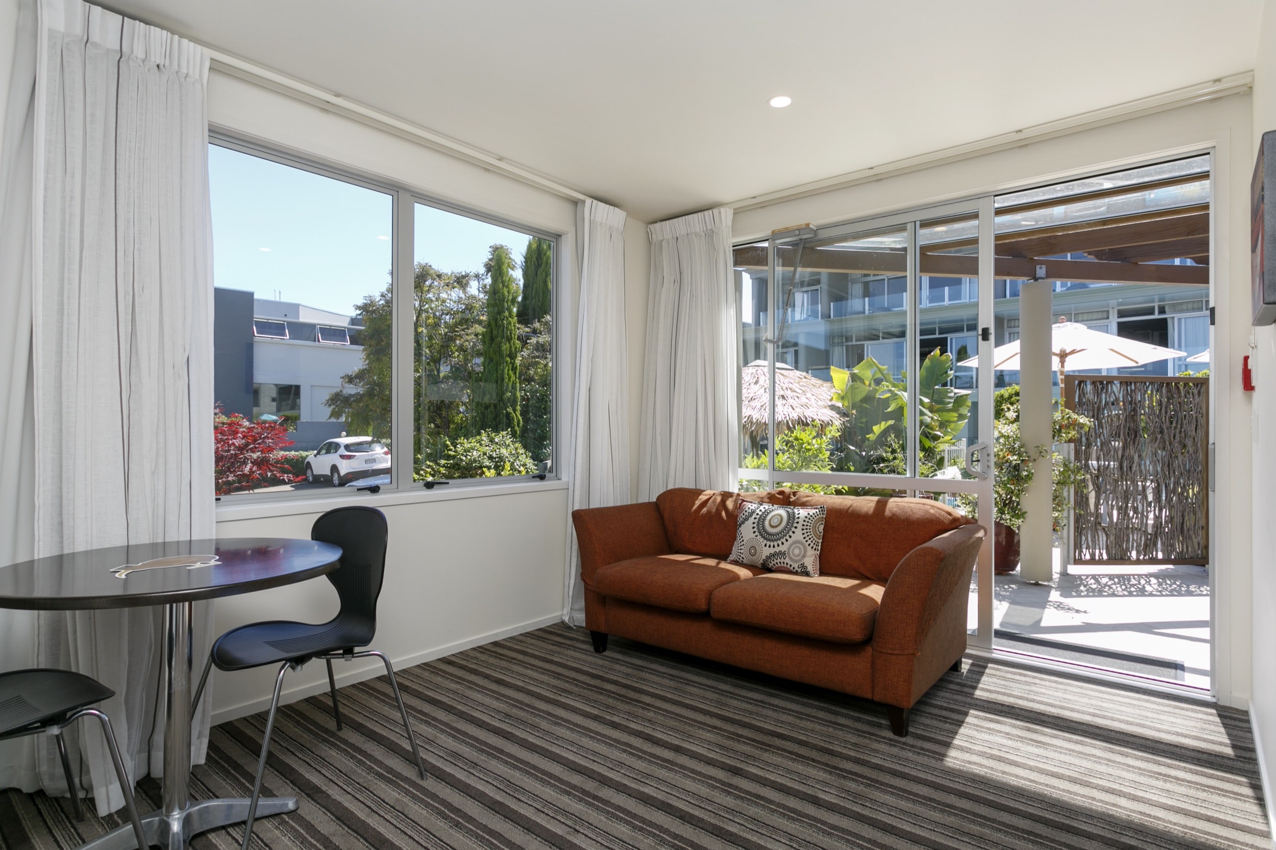 One Bedroom Gardev View living area looking out onto poolside patio area-min.jpg