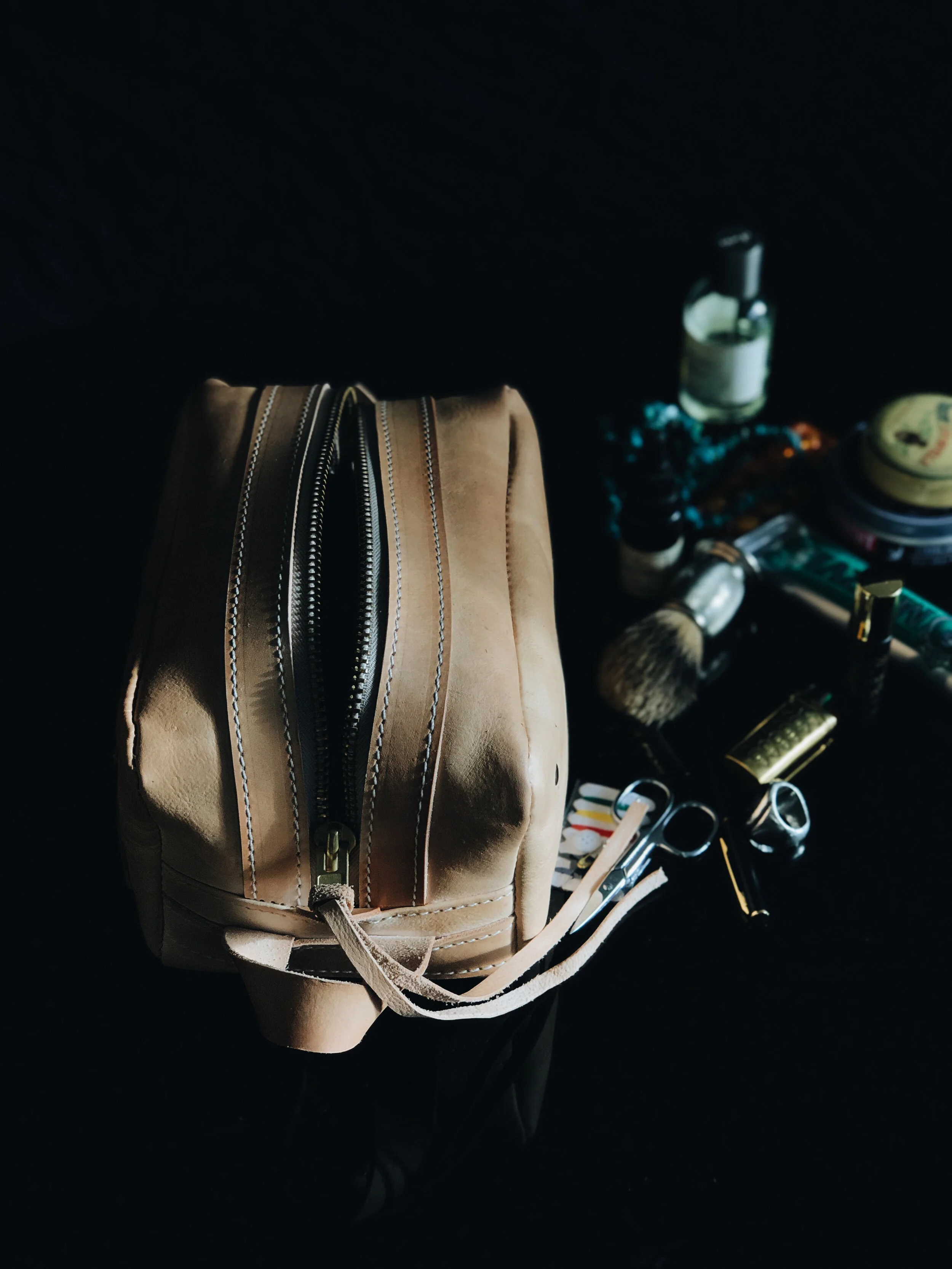 THE POGLIA CARRY ON LEATHER CASE  100% vegetable-tanned  leather that will age and create a patina over time. The YKK rustproof zipper is made from solid brass for reinforcement.