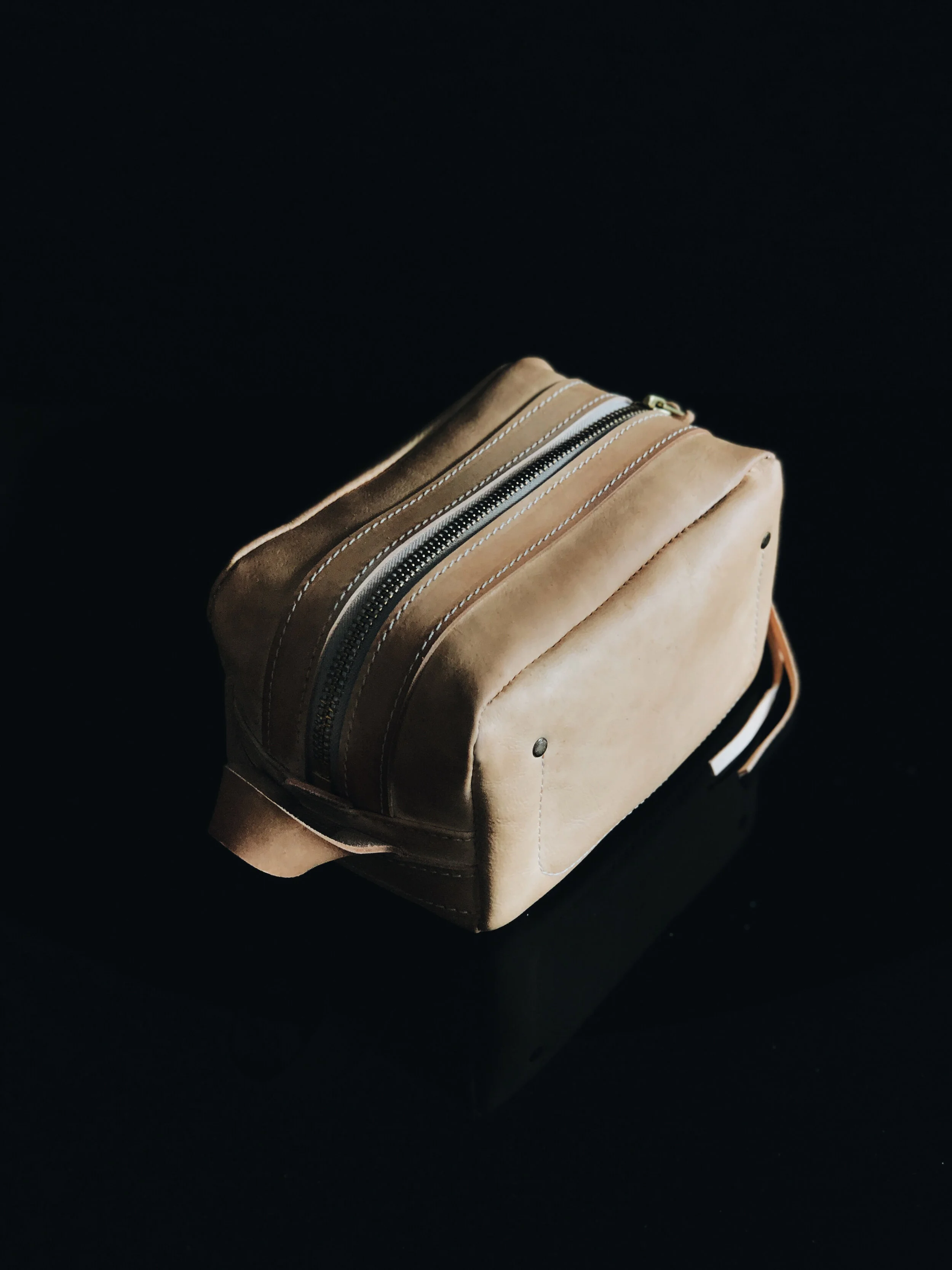 THE POGLIA CARRY ON LEATHER CASE  100% vegetable-tanned  leather that will age and create a patina over time. The YKK rustproof zipper is made from solid brass for reinforcement.