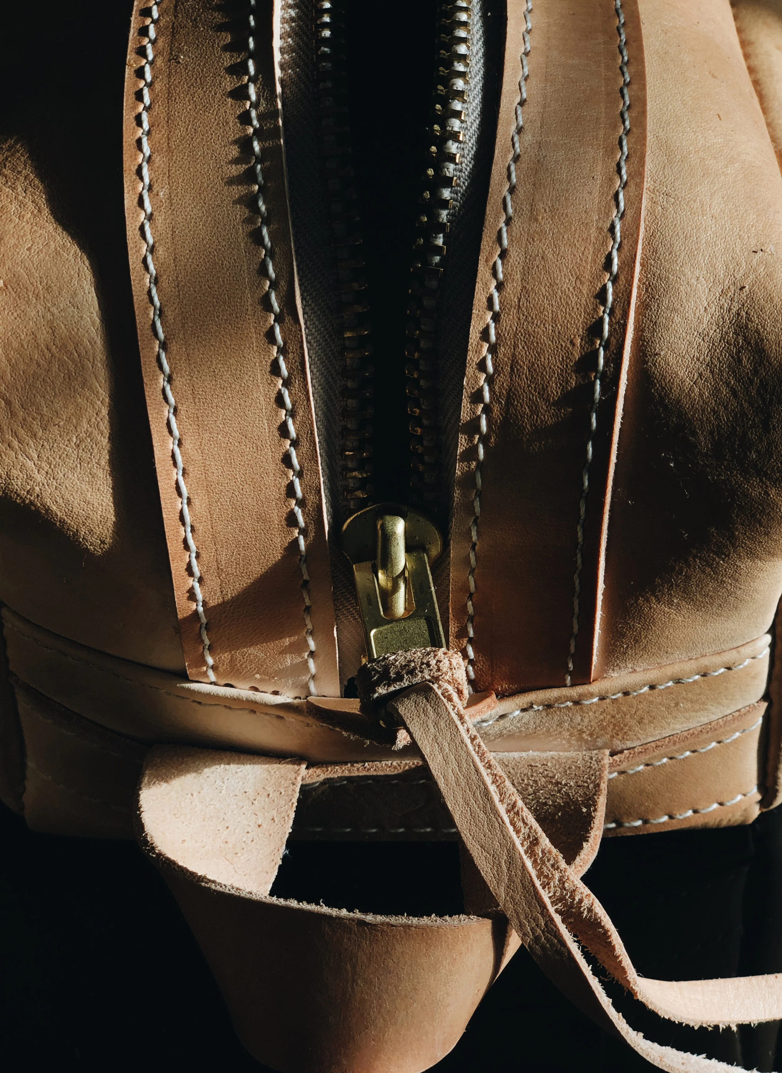 THE POGLIA CARRY ON LEATHER CASE  100% vegetable-tanned  leather that will age and create a patina over time. The YKK rustproof zipper is made from solid brass for reinforcement.