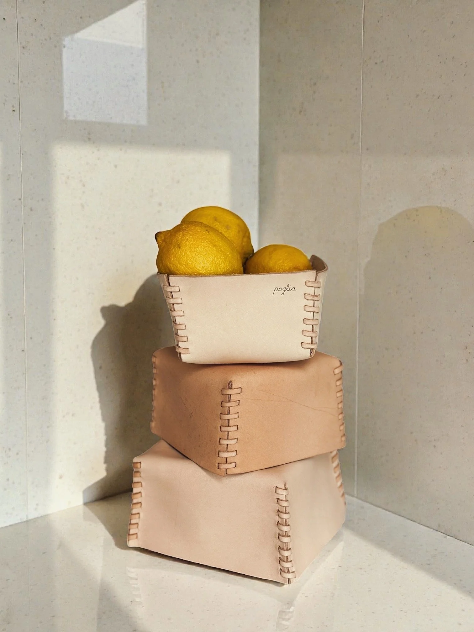 A set of three hand-stitched leather baskets.JPG