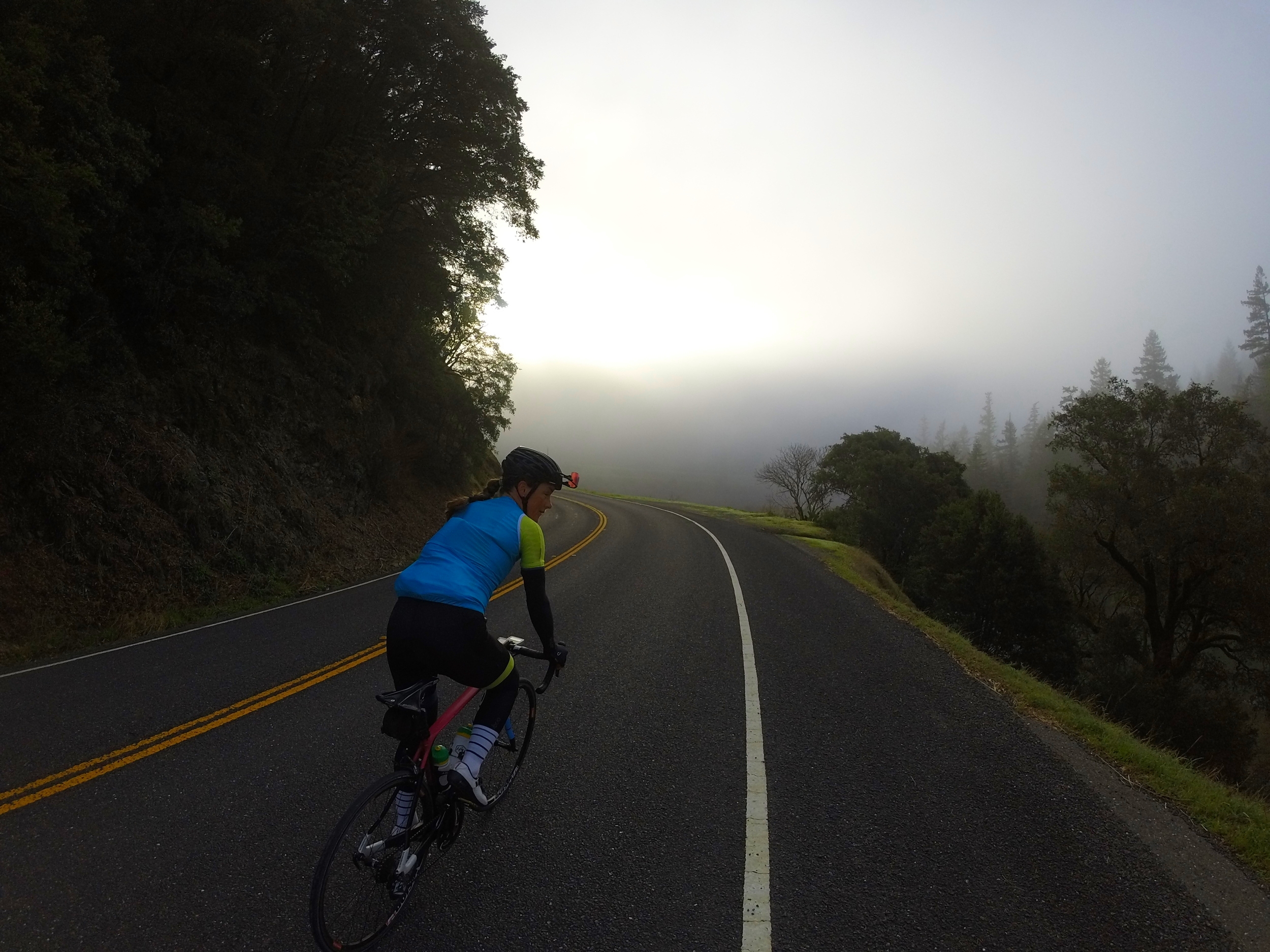 Olivia was a pop of color among the fog in the Citrine ES Jersey & bibs and the cyan wind vest!