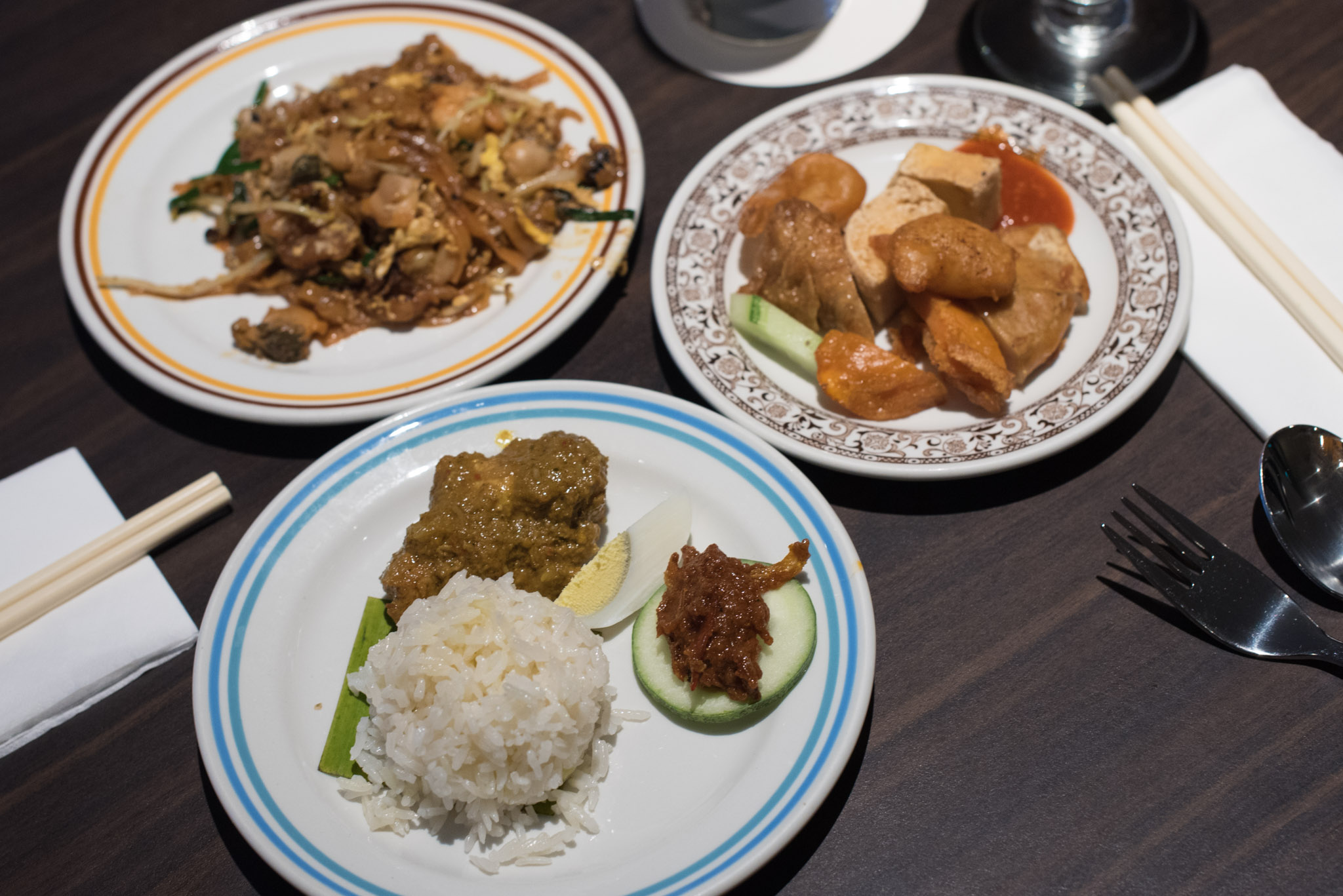 Clockwise from Top Left: Char Kway Teow, Lok Bak, Nasi Lemak with Nonya Chicken Kapitan Penang Hawkers' Fare - York Hotel