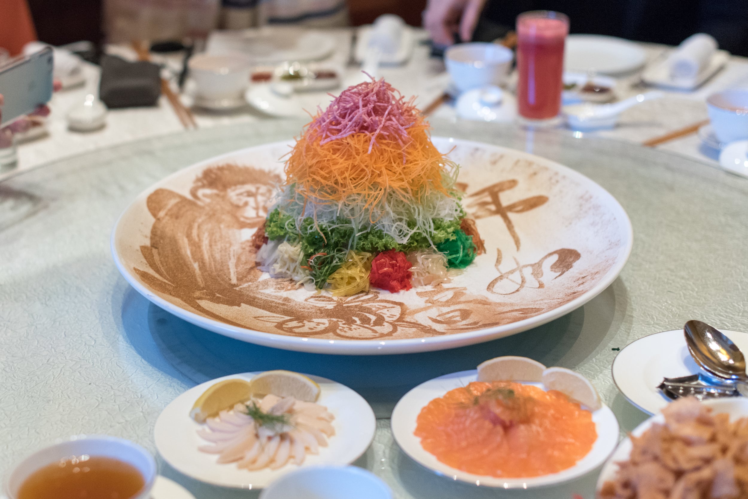 Eight-happiness Gold Rush Salmon Yu Sheng with Champagne Jelly, Olive Oil and Peach DressingJade - The Fullerton Hotel&nbsp;