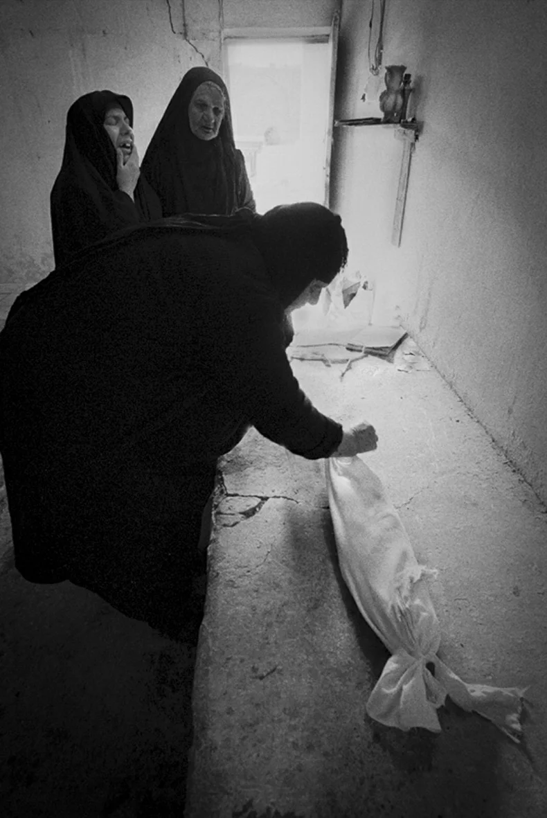 The baby's body being wrapped for burial, Basrah, 1999