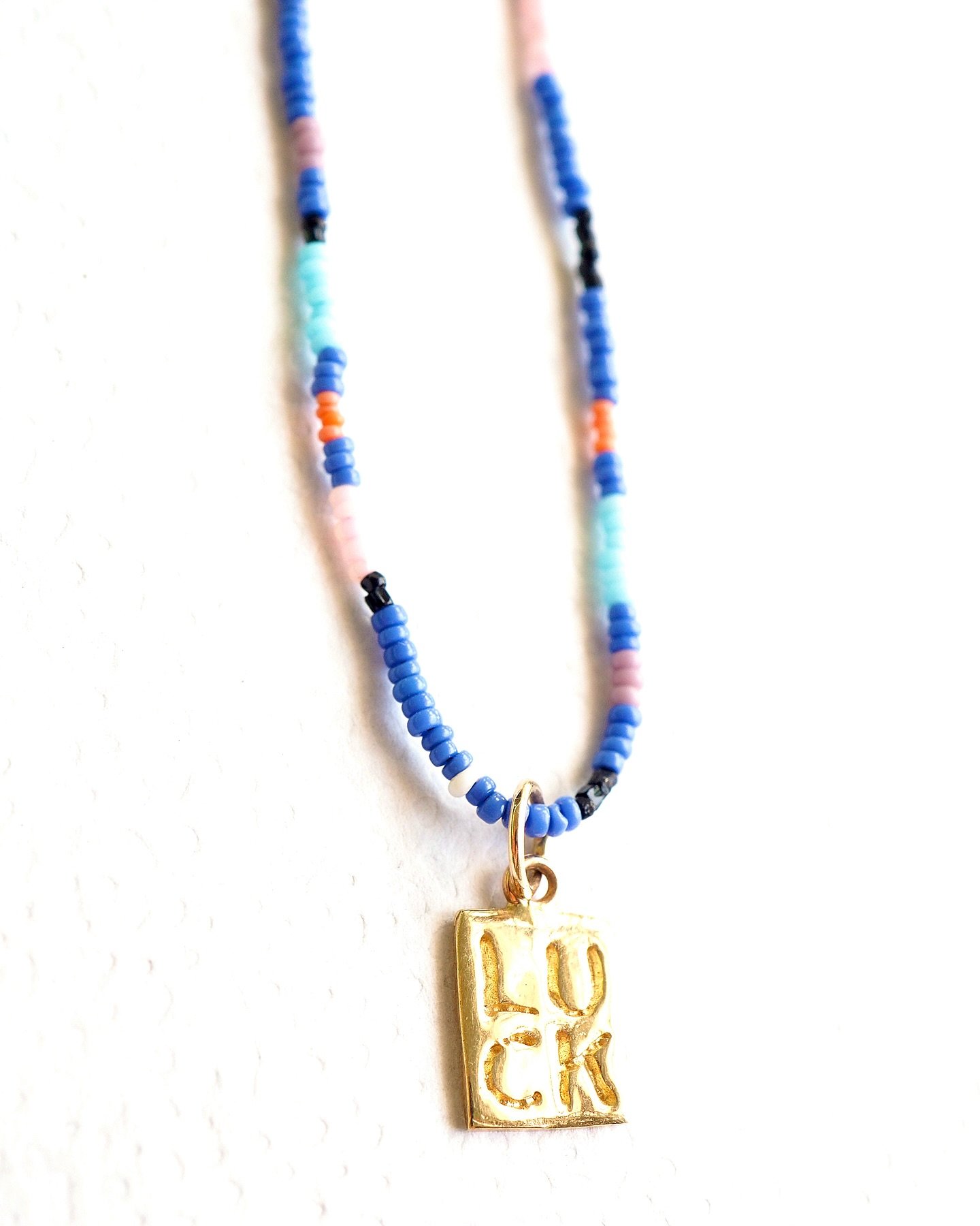The #luckiest #charm - sculpted and inscribed by hand, cast in #14kgold.  #Vintage #Venetian micro seed bead #necklace sold separately.
.
.
.
#beadedjewelry #finejewellery #finejewelry #charms #goldcharm #charmnecklace #mexico #puertovallarta