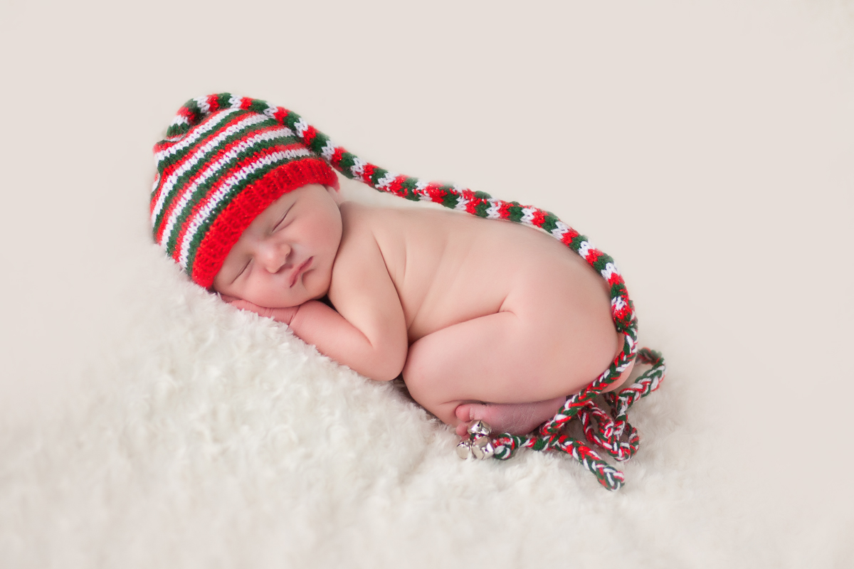 Newborn sleeping in stripped hat