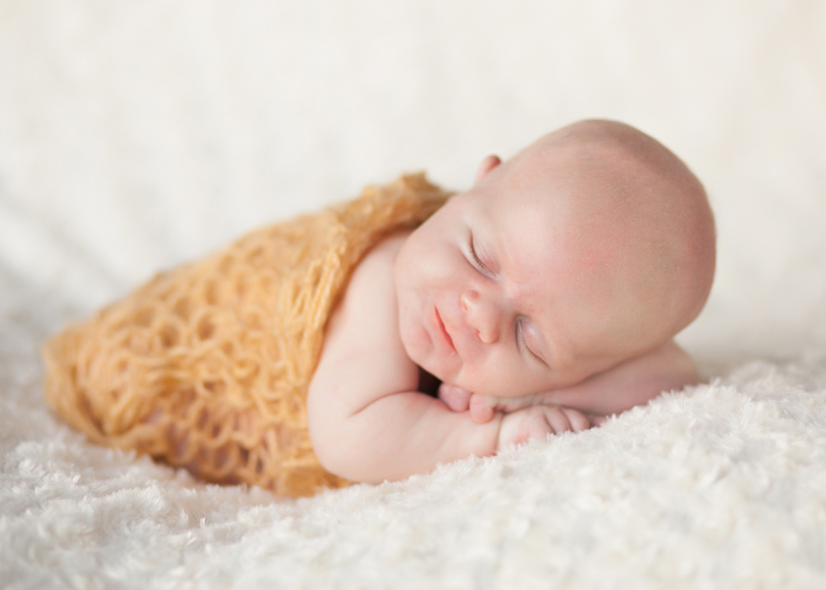 newborn sleeping on belly