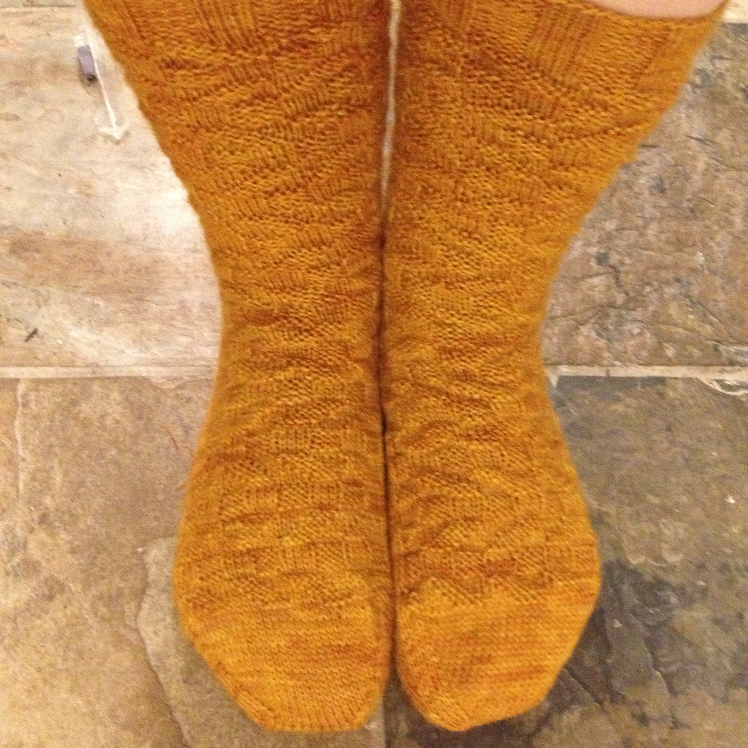 My blurry iPhone photos don't do this pattern, or the yarn justice, (and it doesn't help that my feet are much smaller than Jim's)