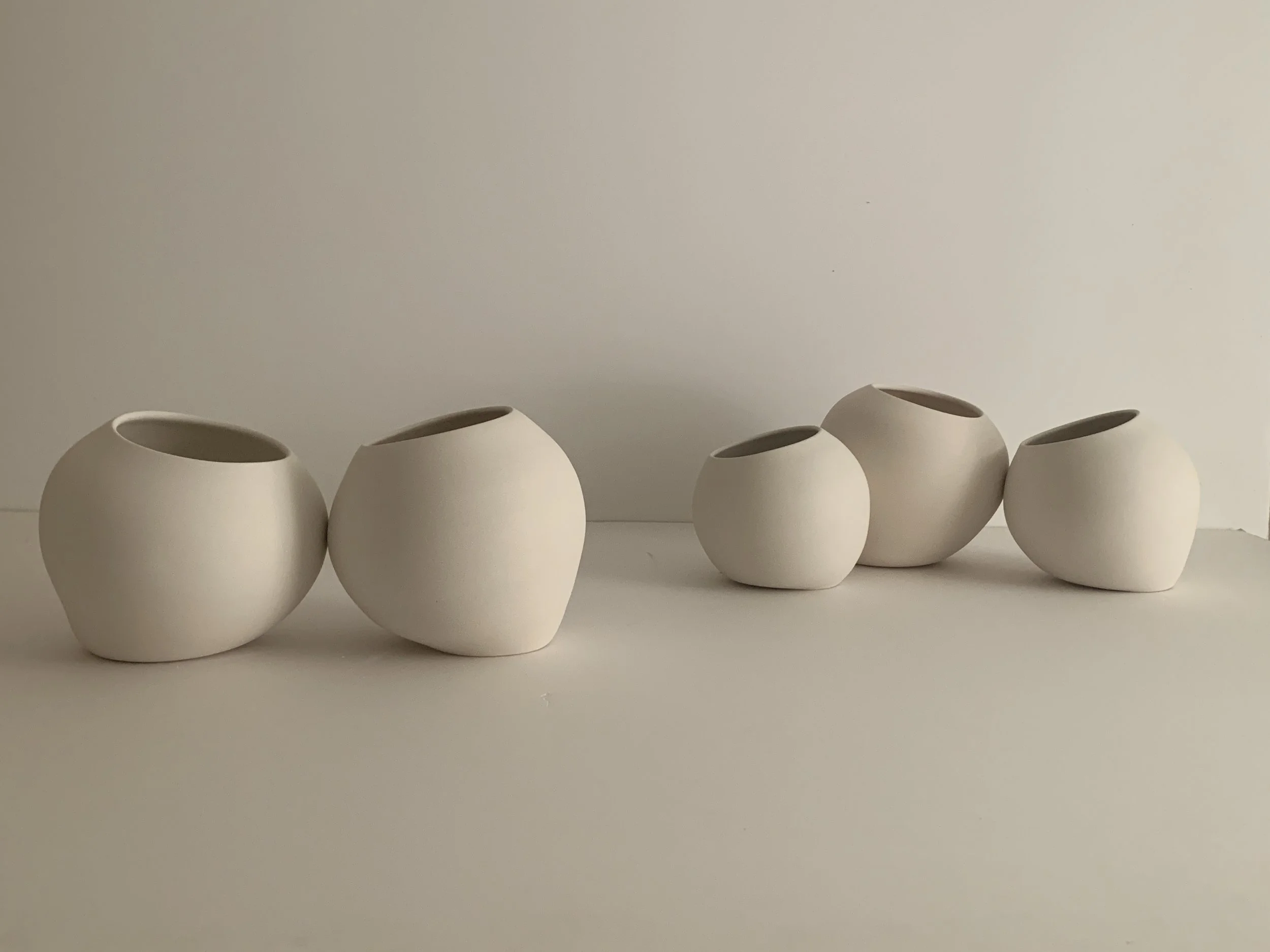    Conversations.    Study for a large scale, multi sensory installation inspired by the COVID pandemic.  It is a commentary on community, exploring our innate need for human touch and connection.  Small groupings of nuzzling porcelain orbs will sit 