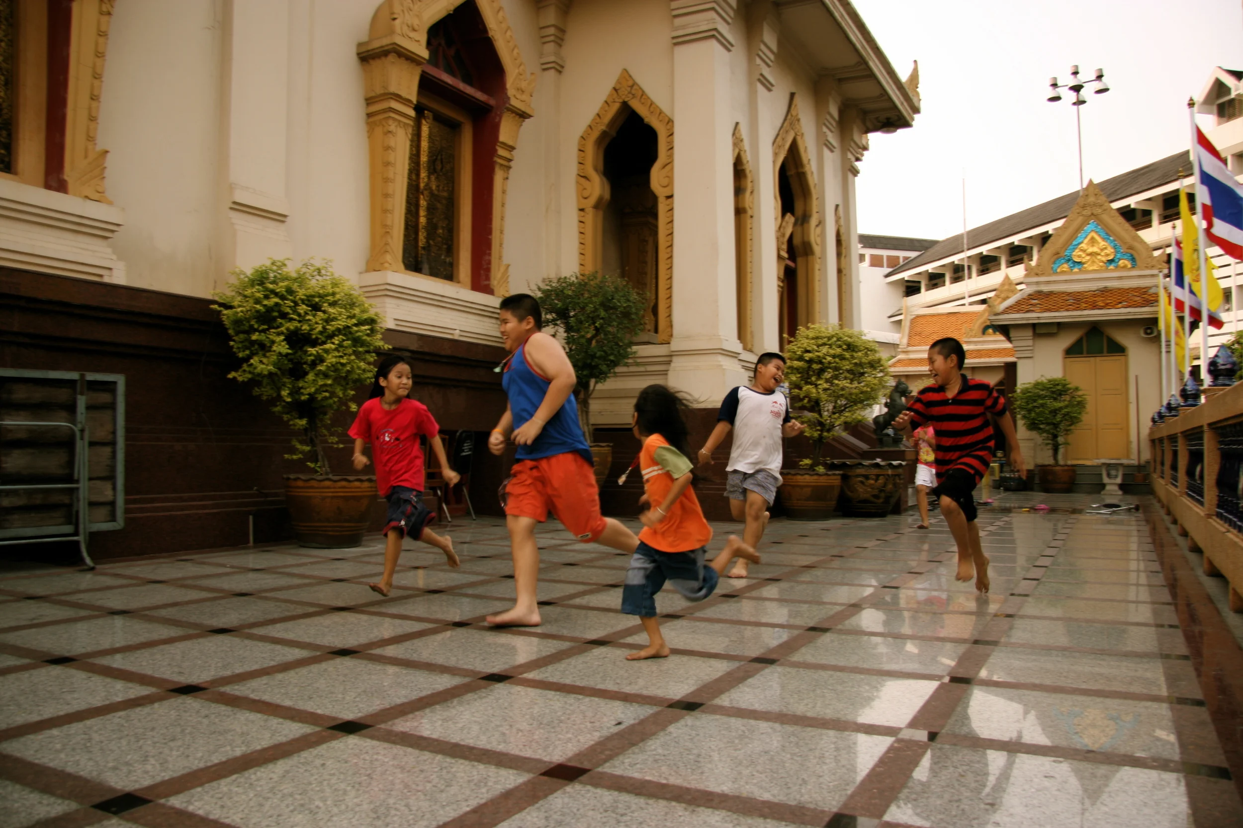 The primary focus of all kids sport - having fun. Unknown temple in Bankgok, Thailand. I got to watch these kids run non-stop for hours on end - non-stop smiles :)