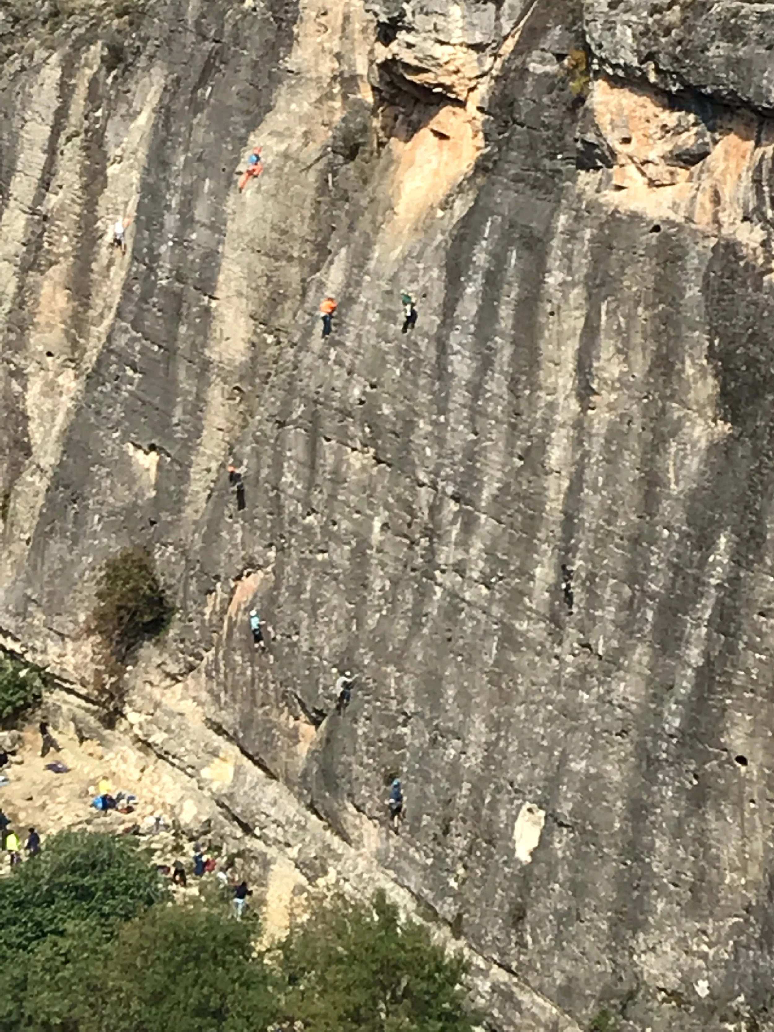 zoomed perspective on number of climbers at the crag