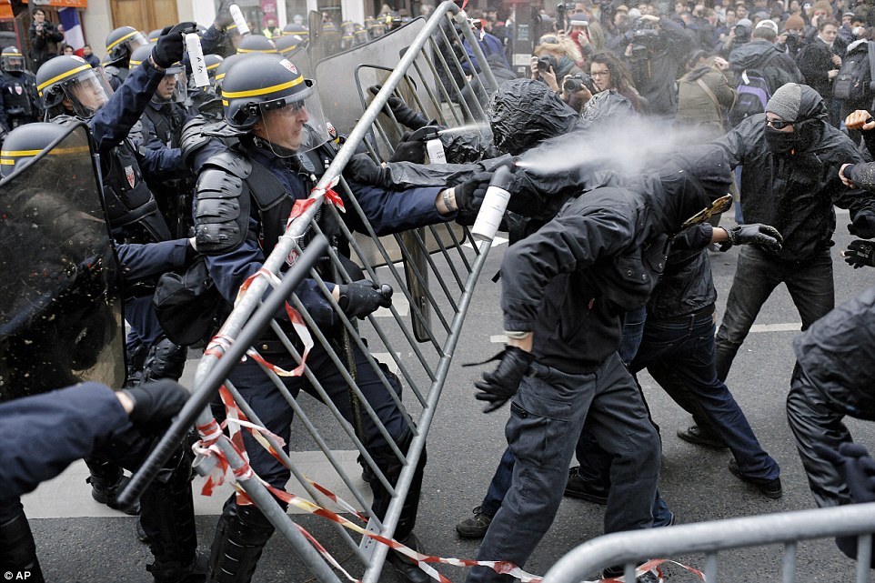 2EE7FA9800000578-3338255-Hitting_back_One_riot_police_officer_sprays_a_large_amount_of_sp-a-46_1448820978371.jpg