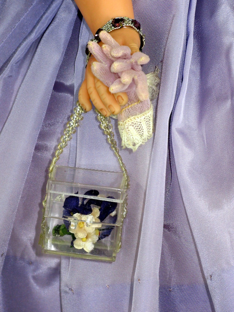 Cissy's lucite purse with floral accents matching her dress and millinary.