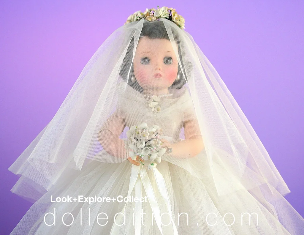 Elise 1957 Bride #1650 - nylon tull gown with chapel length veil falling gracefully over her face and held in place with a coronet of flowers.