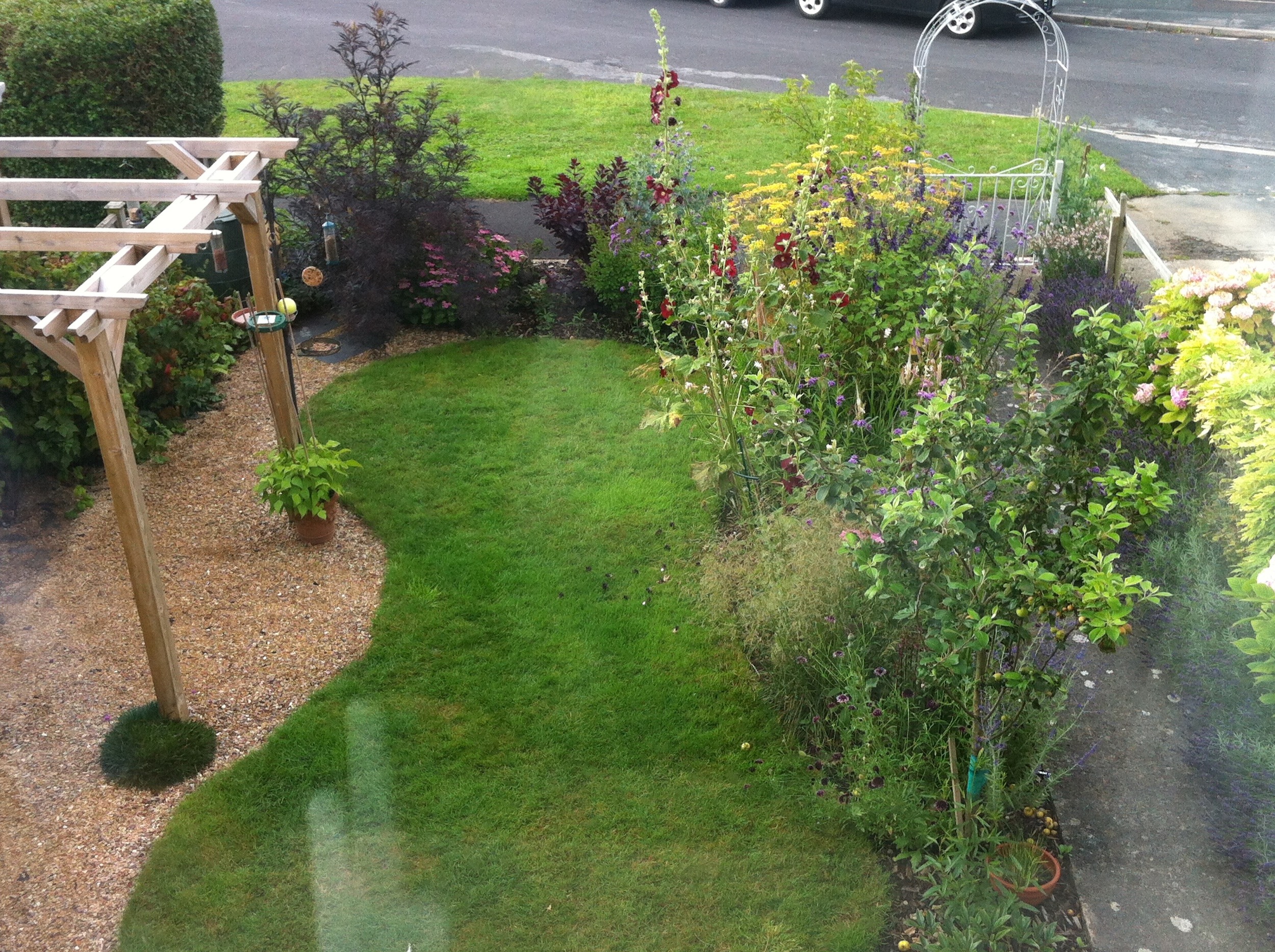 After: flower border, shaped lawn and pergola (with swing!)