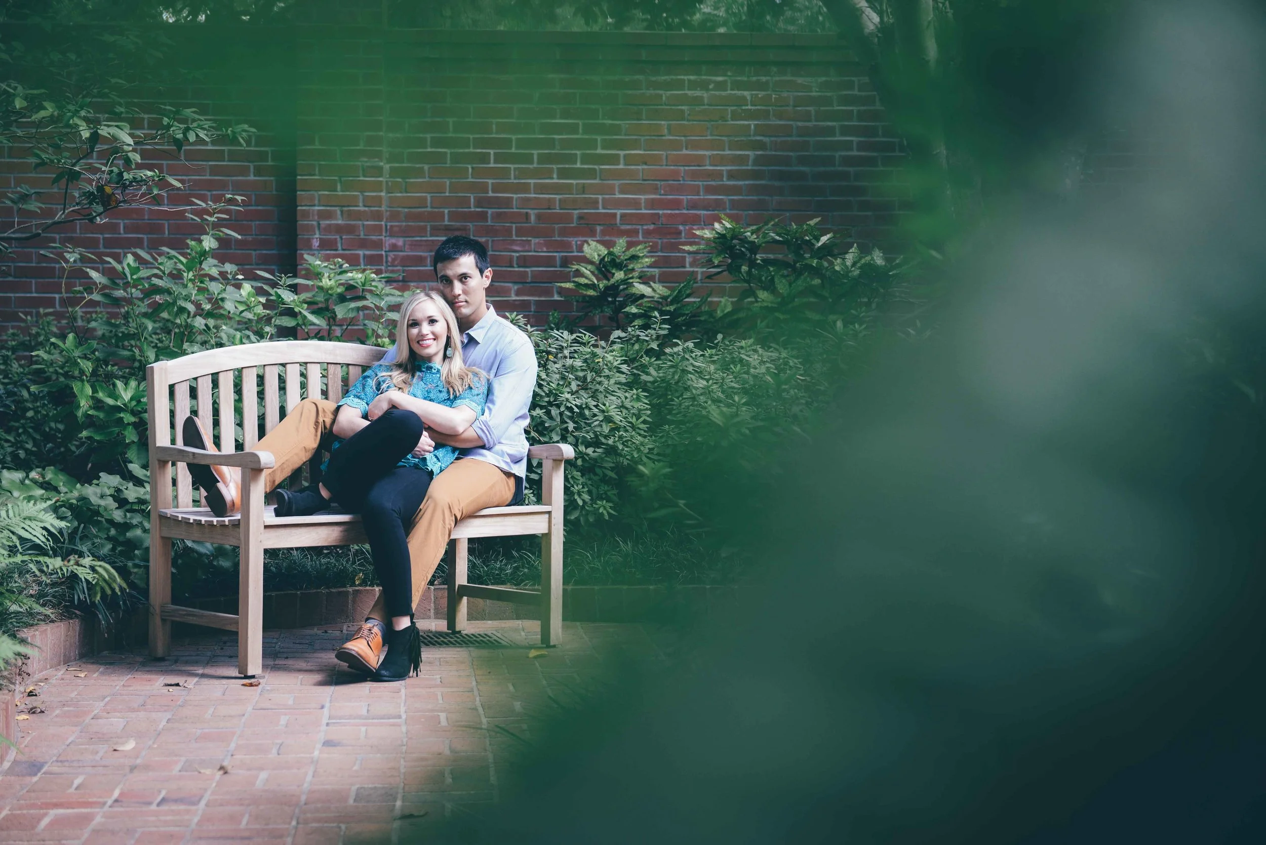 guy and girl sitting on wooden bench