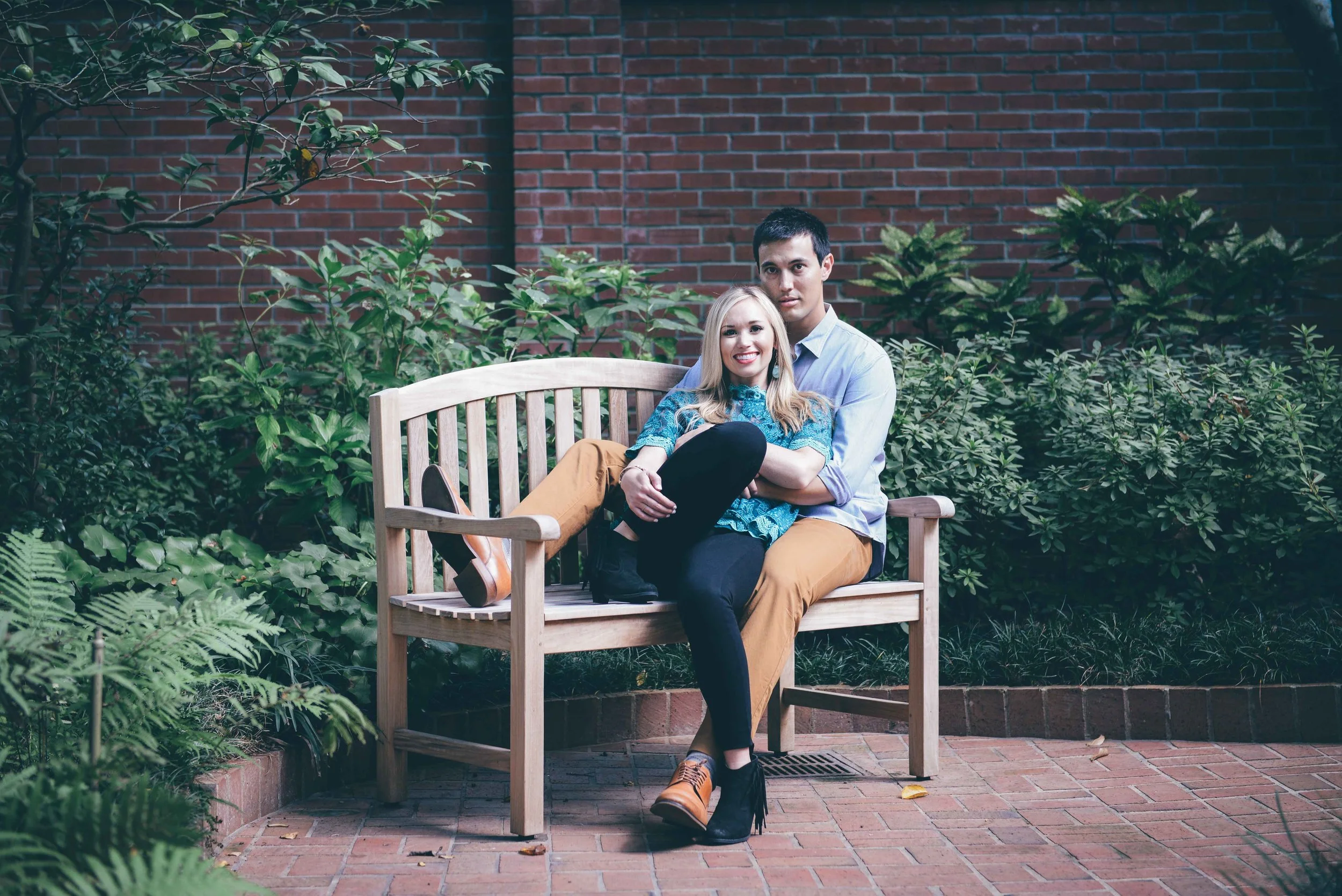 guy and girl sitting on wooden bench
