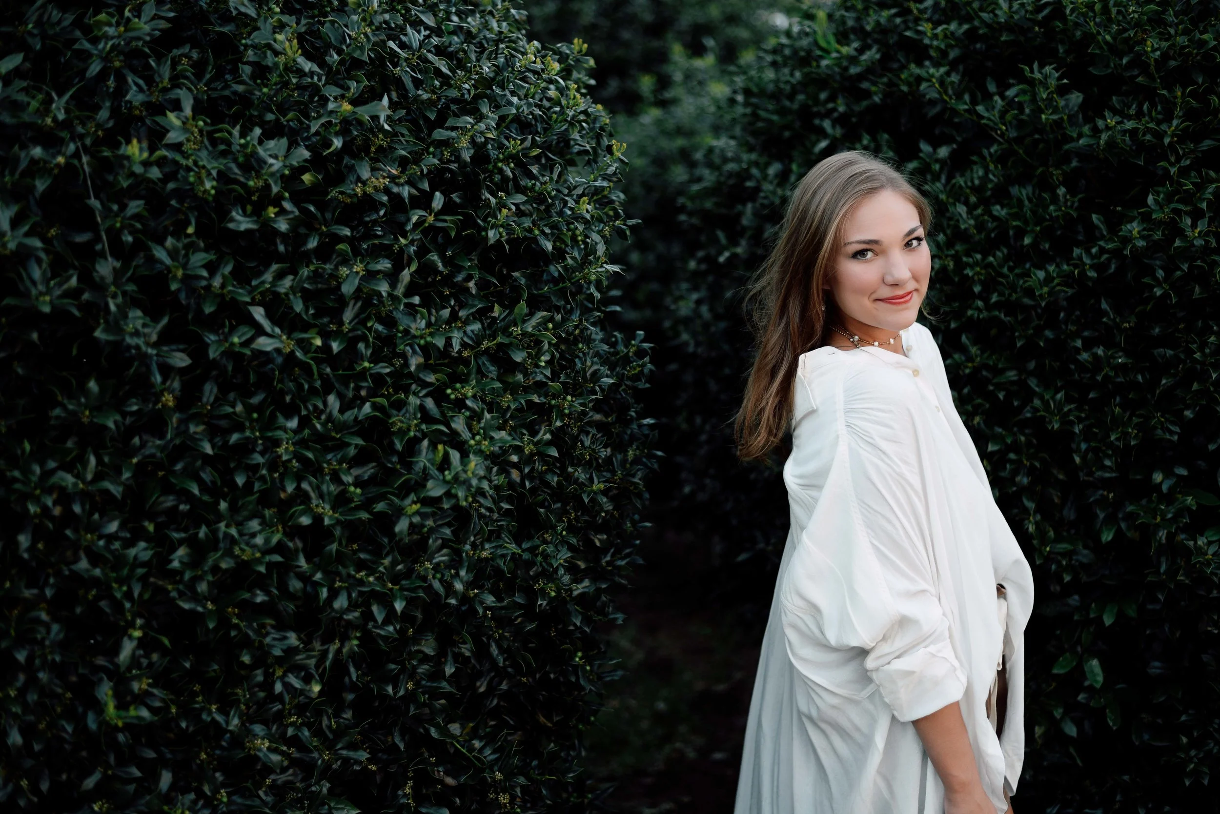 girl posing in bushes