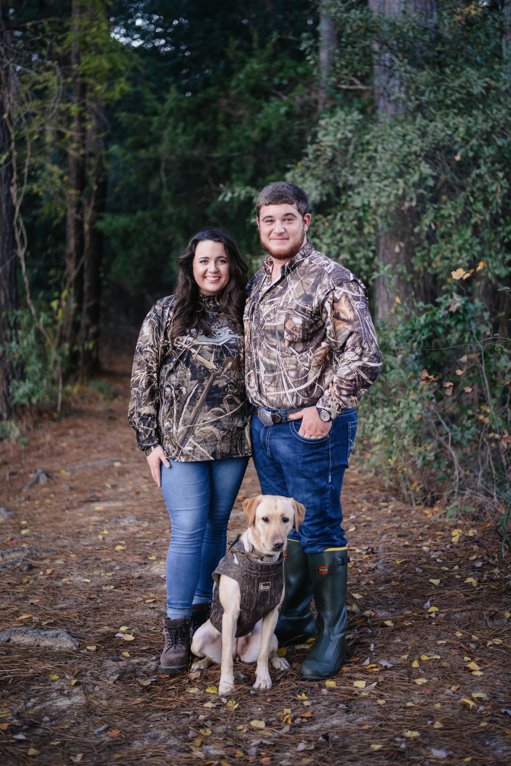 engaged couple in camo with dog
