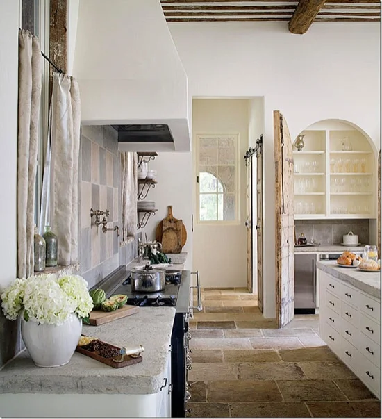 Breadboards with their cuts and scrapes exposed add authenticity to a kitchen and give it a sense of history, an instant backstory that hints at all the delicious things previously cooked. Interior Design by Annelle Primos. Photo by Chipper Hatter via here .