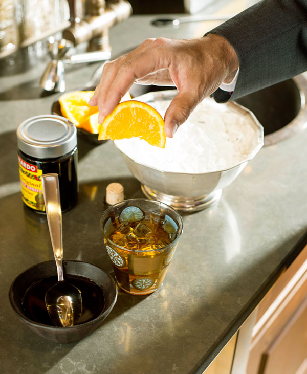 Drop in a slice of orange and a maraschino cherry, preferably a Luxardo cherry. They are ambrosia. Don't muddle them. Let them be suspended in the alcoholic bath.