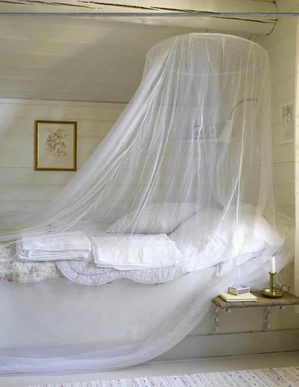 Romantic, serene, lovely (above). But the gooseneck lamp makes the whole thing look like a shower stall. Plus that candle could ignite the netting in a flash. Safety, people, especially in the bedroom, is always your friend. Photo by Per Erik Jaeger via here .