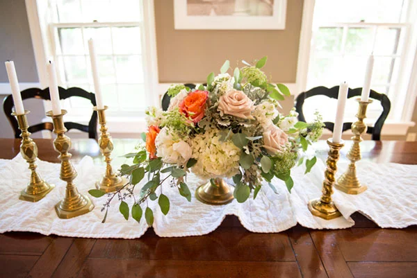 Vintage brass candlesticks and pedestal stand. Aren't those orange roses so over-the-top and luscious?
