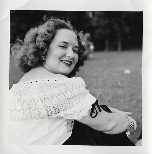 Violet VanDoren Eliason, Melody's grandmother, wearing white eyelet trimmed with black grosgrain ribbon, dangly earrings, an armful of bangles, and a beautiful smile. She had style!