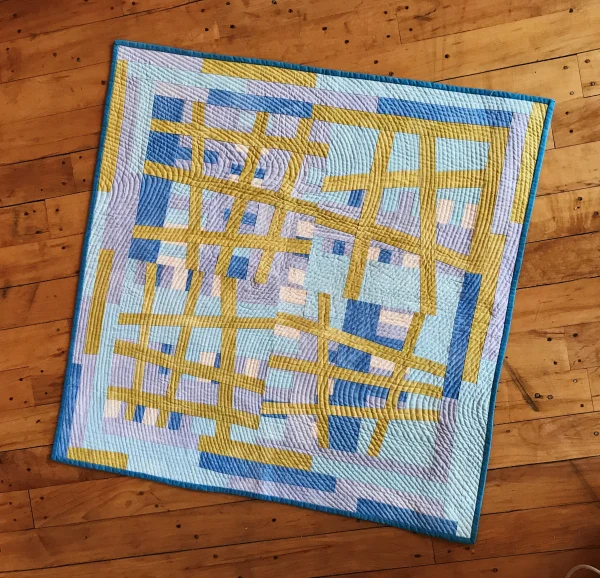 Cathy made this quilt during a six-month sojourn in Oxford, England, using a cheap Singer sewing machine that she purchased and lugged home on the bus. I love the abstract lines and how the curved hand stitching creates an effect of undulating motion.