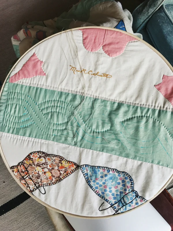 Cathy purchased this old, unfinished quilt with the signatures of the original seamstresses written in pencil on the squares. She researched the names on Ancestry.com and surmised that the quilt likely originated in Springfield, Ohio. She invited other quilters to an old-fashioned quilting bee to complete the quilt, and now hopes to travel to Springfield to return the quilt to its place of origin.