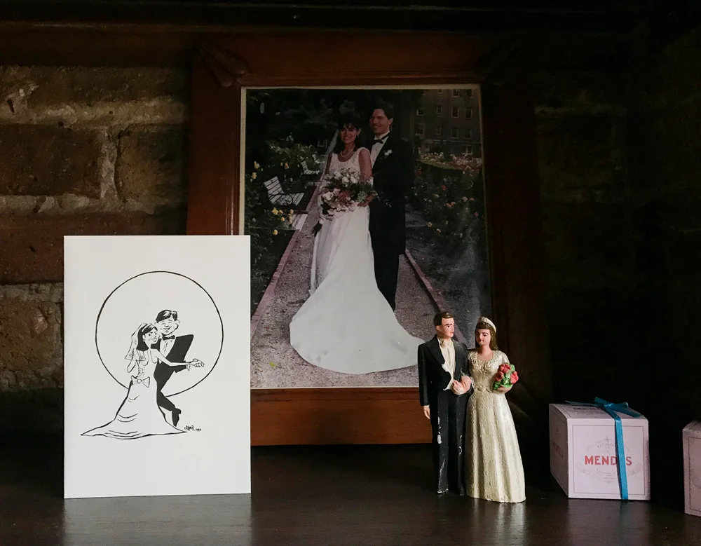 Mike is an attorney who moonlights as a cartoonist, visual artist, writer, and film producer. He designed their 1989 wedding invite. As befits these two, they said their vows in an interfaith ceremony in a beautiful city park. I remember how hot it was, or it felt that way to me, pregnant with our first, and I remember how Harlene glowed like a dark angel.
