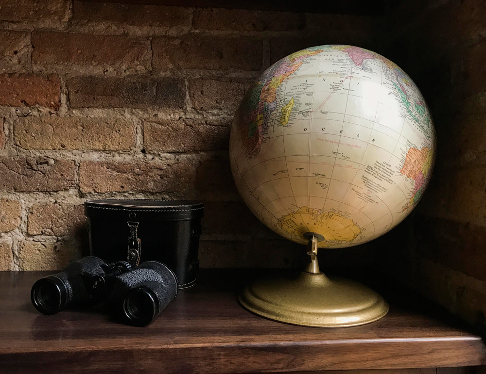 Their Printer’s Row loft once housed the headquarters of The Adventurer’s Club. Mike and Harlene themselves are intrepid globetrotters and the apartment is filled with references to travel. You’ll spot suitcase chairs, suitcase shelves, suitcase side tables, globes, maps, and of course, plenty of exotic souvenirs. The binoculars above belonged to Mike’s father.