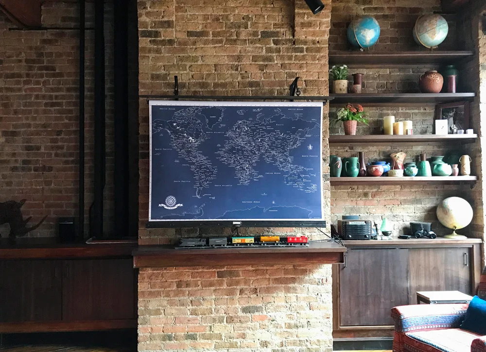 The custom roll-up map on the wall hides the television. The Lionel trains belonged to Mike’s father, who worked for Frisco in St. Louis and then Grand Trunk in Detroit. The vintage radio belonged to Mike’s grandfather.