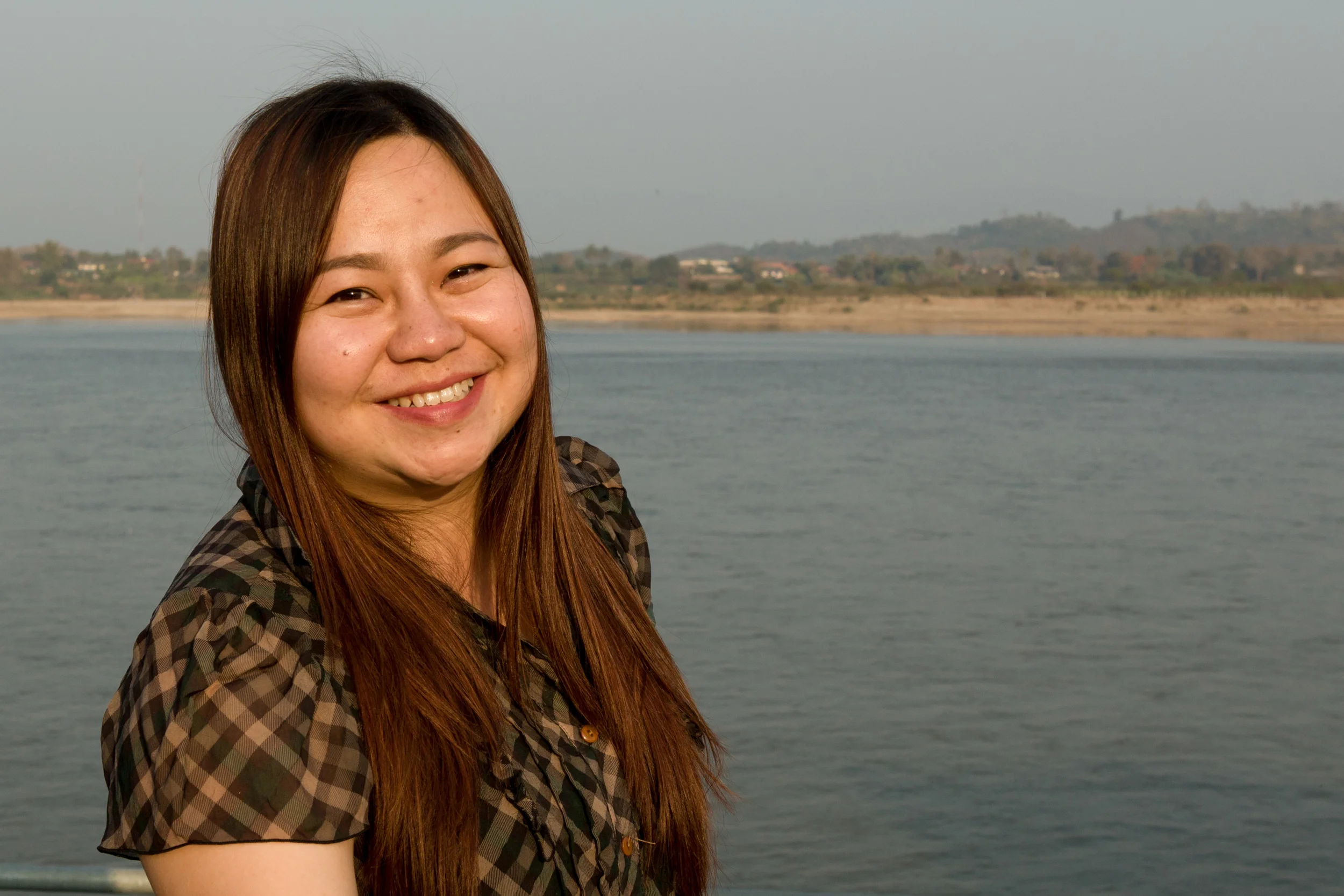 Khun Rungnapa Boonklueab, also known as "Noy," on the banks of the Mekong in her hometown of Chiang Saen. Laos PDR is right across the river. 