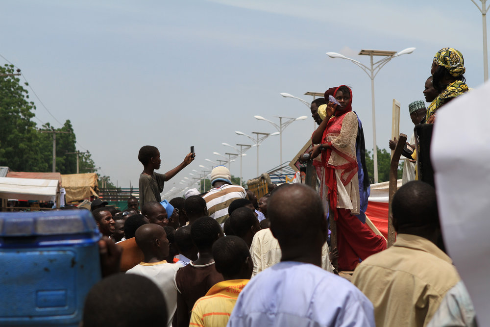  Here, kids crowd around a truck during a "polio rally". Performers sang as the truck drove around the streets of Maiduguri.&nbsp; 