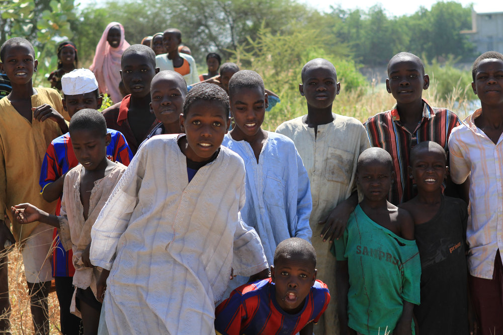  We take a boat up a canal towards Lake Chad. These boys were gathered on the shore to say hello. I'm certain this area has been badly hit by Boko Haram.&nbsp; 