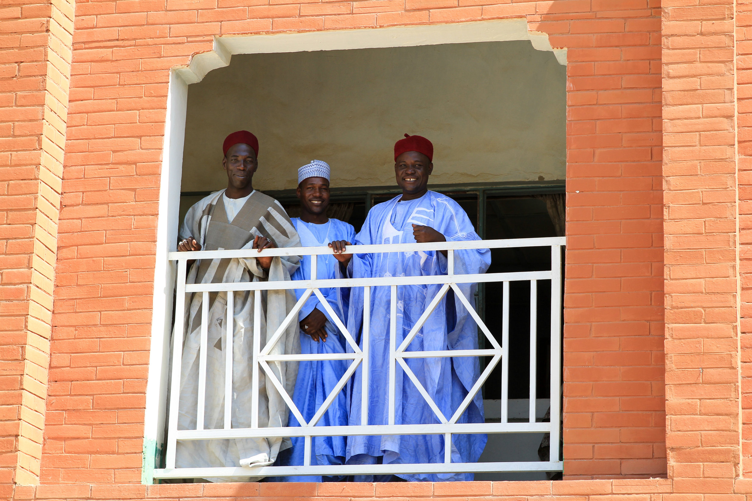 These men smile and wave as we get in our truck, to leave. 