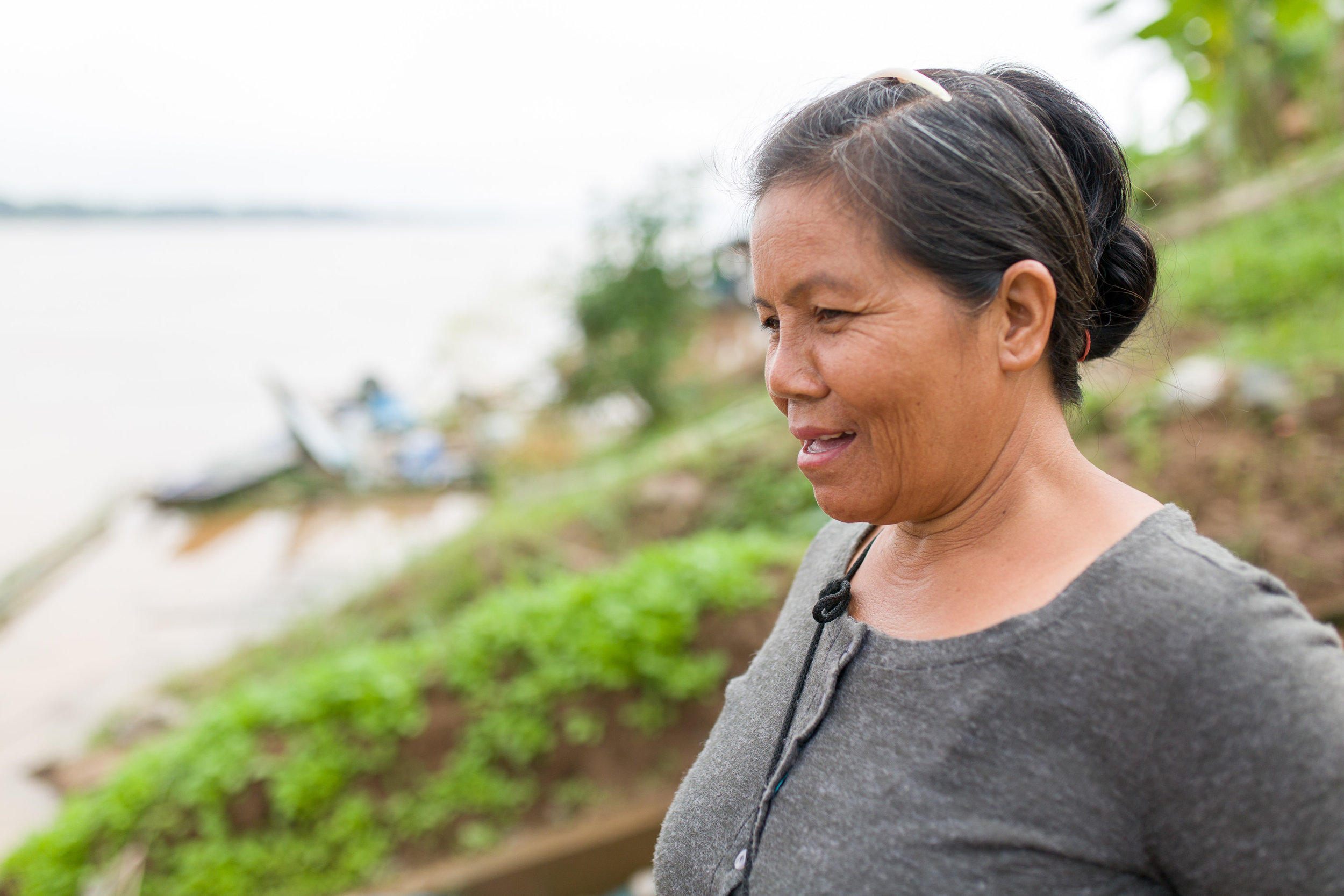 Khun Saman, or "Man" for short, stands by the Mekong river. 