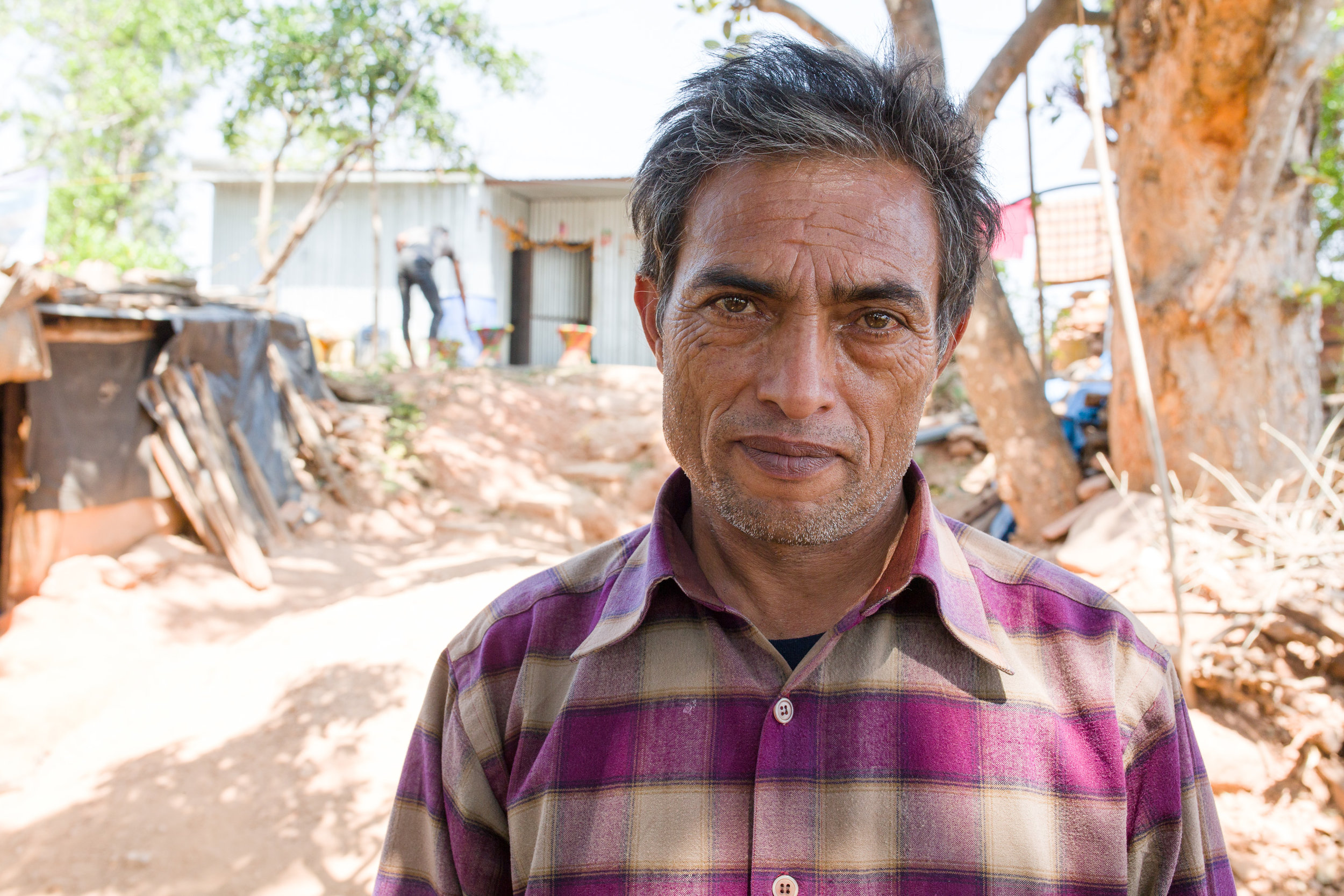 Narayan Giri's mother died from injuries she sustained in the earthquake. Here Narayan stands in front of his new temporary home. 