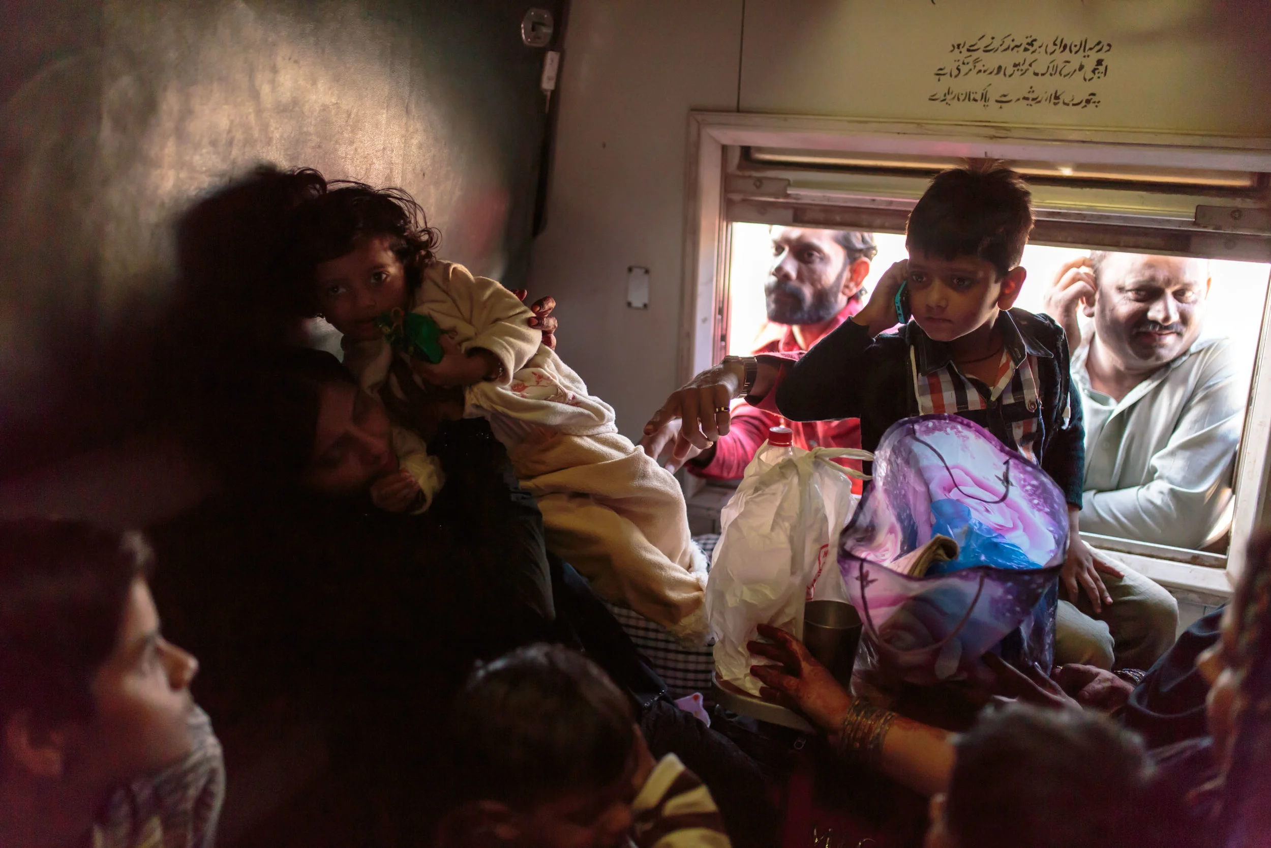 Families wait for the train to leave the station in Karachi, Pakistan. 