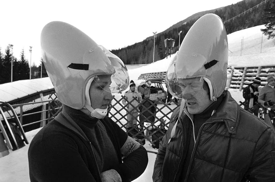 In 1976, members of the West German luge team, Elisabeth Demleitner and Stephan Hoelzlwimmer, wear the latest design in helmets during a practice session on the Olympic Luge course in Innsbruck, Austria, on Friday, on January 30, 1976. 