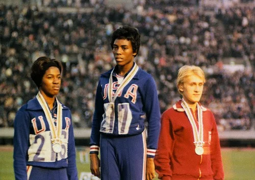 During the Mexico City games in 1968, Wyomia Tyus faced an atmosphere of racial tension. African American athletes threatened to boycott the games. Although the boycott never occurred, two sprinters, bronze medalist John Carlos and gold medalist Tommie Smith, were suspended from the U.S. team for raising a Black Power salute during their victory ceremony. For Tyus the 1968 games were personally and professionally important. She won gold in the 100-meter dash for a second consecutive time, something no one else did until Carl Lewis competed twenty years later, and she also proved herself the fastest woman in the world for a second time. In response to the suspension of her fellow athletes, Tyus's 400-meter relay team, which won the gold medal and set a new record, dedicated their medal to Carlos and Smith.