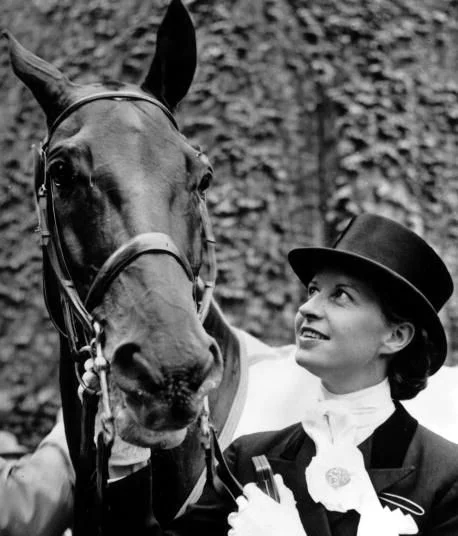 A seven time Danish dressage champion, Hartel contracted polio at age 23 while pregnant with her second child. Despite being paralyzed from the knees down, Hartel ignored the advice of her doctors and spent three years regaining the use of her limbs and re-learning the sport. In 1952, she became one of the first women to compete against men in Olympic equestrian events, winning a silver medal. Still suffering the effects of polio, Hartel was unable to mount and dismount on her own - gold medal winner Henri Saint Cyr carried her to the podium for the medal ceremony. After retiring, Hartel trained young Danish riders and founded Europe's first therapeutic riding center. In 1994, she became the first Scandinavian inducted into the International Women's Sports Hall of Fame. 
